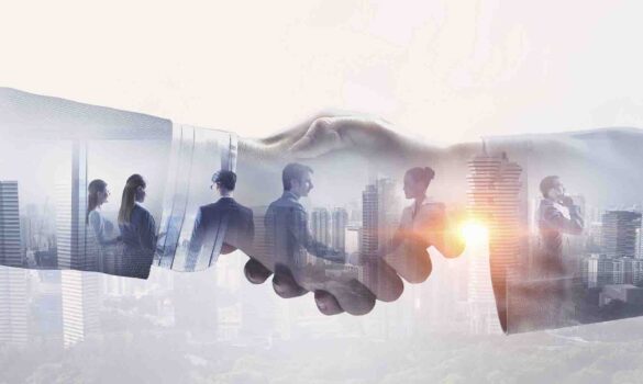 Business people shaking hands in front of a cityscape.