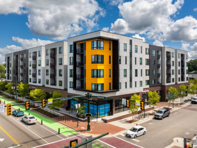 Modern apartment building with yellow facade.